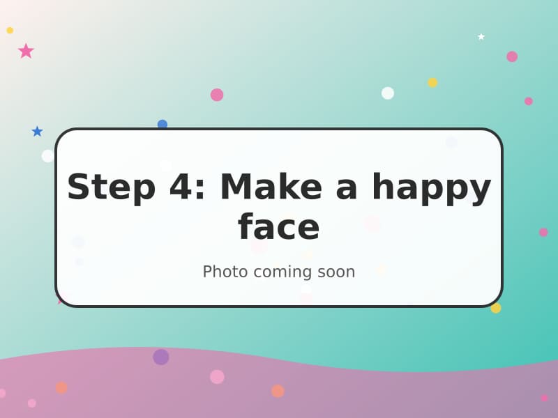 A paper caterpillar face with googly eyes and a smile